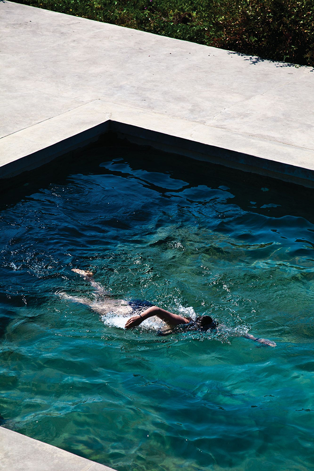 Hotel guest swimming in pool