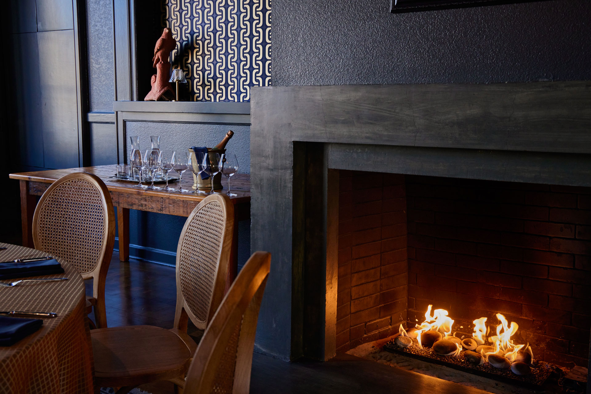 Fireplace, dining table and iced champagne